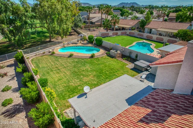 an aerial view of a house with a yard