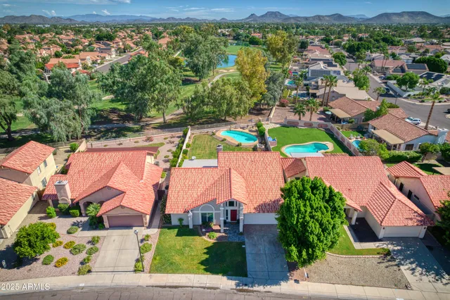 an aerial view of residential houses with outdoor space and street view