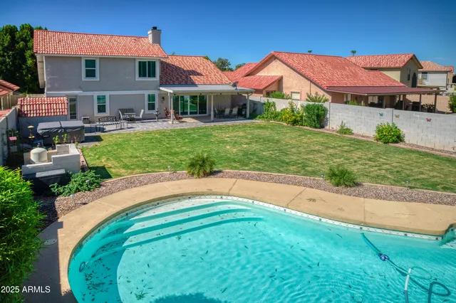 a backyard of a house with yard and outdoor seating