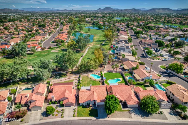 an aerial view of residential houses with outdoor space and street view