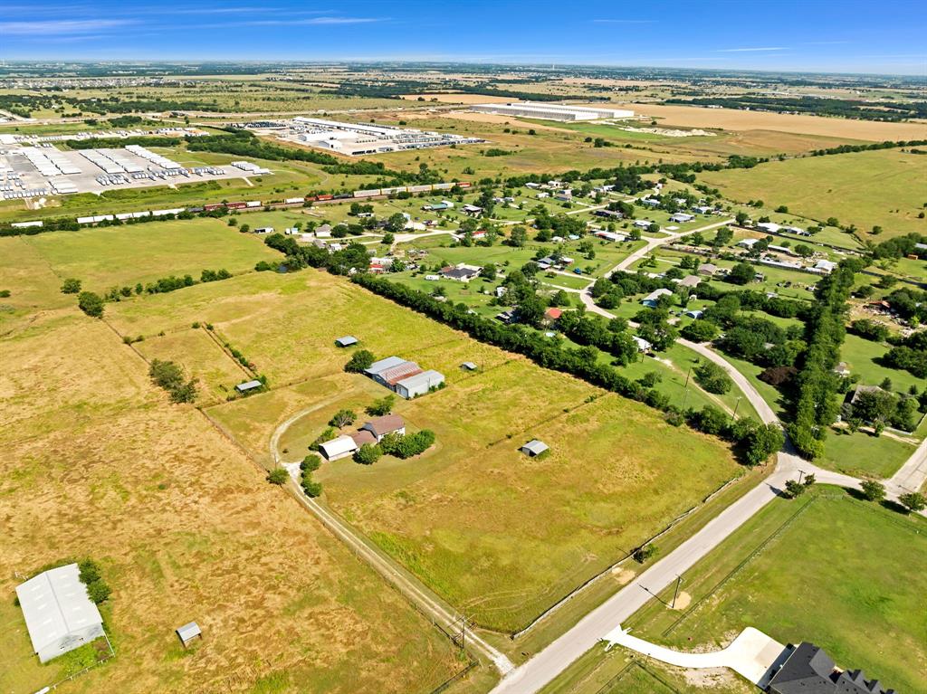 1795 Melton Road Sanger, TX 76266 - Photo 4 of 17 Expansive rural property featuring a main residence with attached garage, multiple outbuildings, and extensive open land