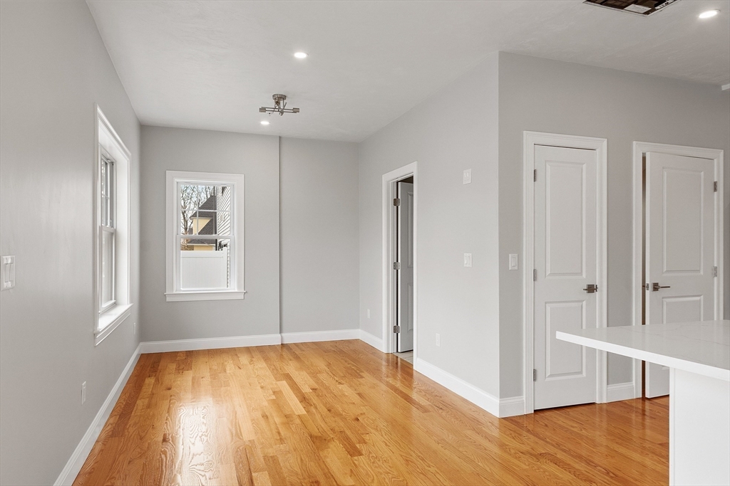 10 Windsor Street Worcester, MA 01605 - Photo 6 of 26 a view of empty room with wooden floor and window