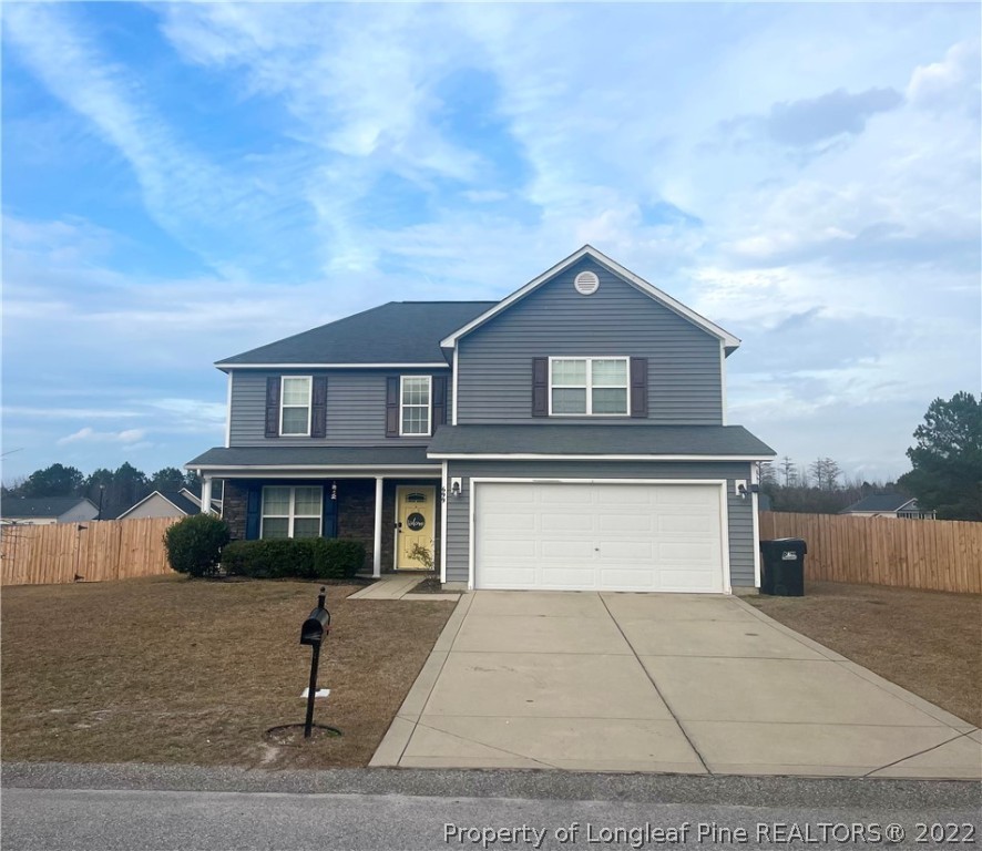 699 Cape Fear Road Raeford, NC 28376 - Photo 1 of 35 a front view of a house with a garage