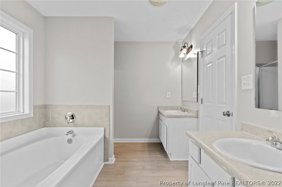 699 Cape Fear Road Raeford, NC 28376 - Photo 21 of 35 a bathroom with a tub sink and mirror