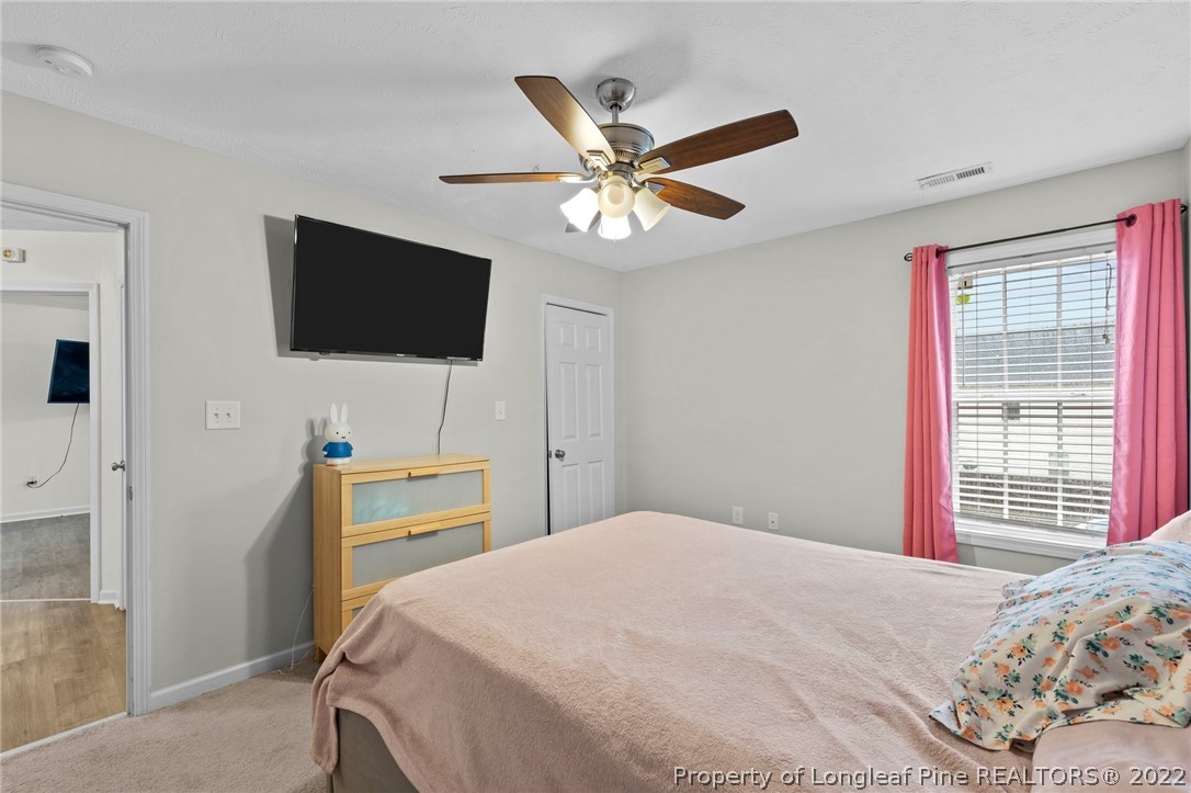 699 Cape Fear Road Raeford, NC 28376 - Photo 23 of 35 a bedroom with a bed and a flat screen tv