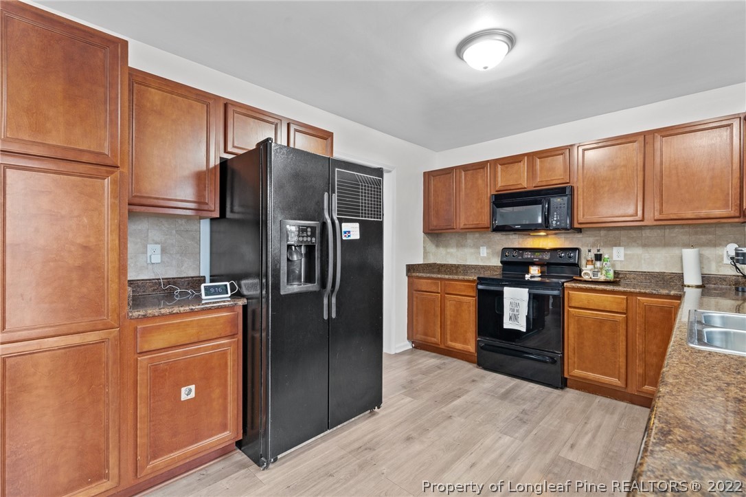 699 Cape Fear Road Raeford, NC 28376 - Photo 5 of 35 a kitchen with stainless steel appliances granite countertop a refrigerator stove and microwave