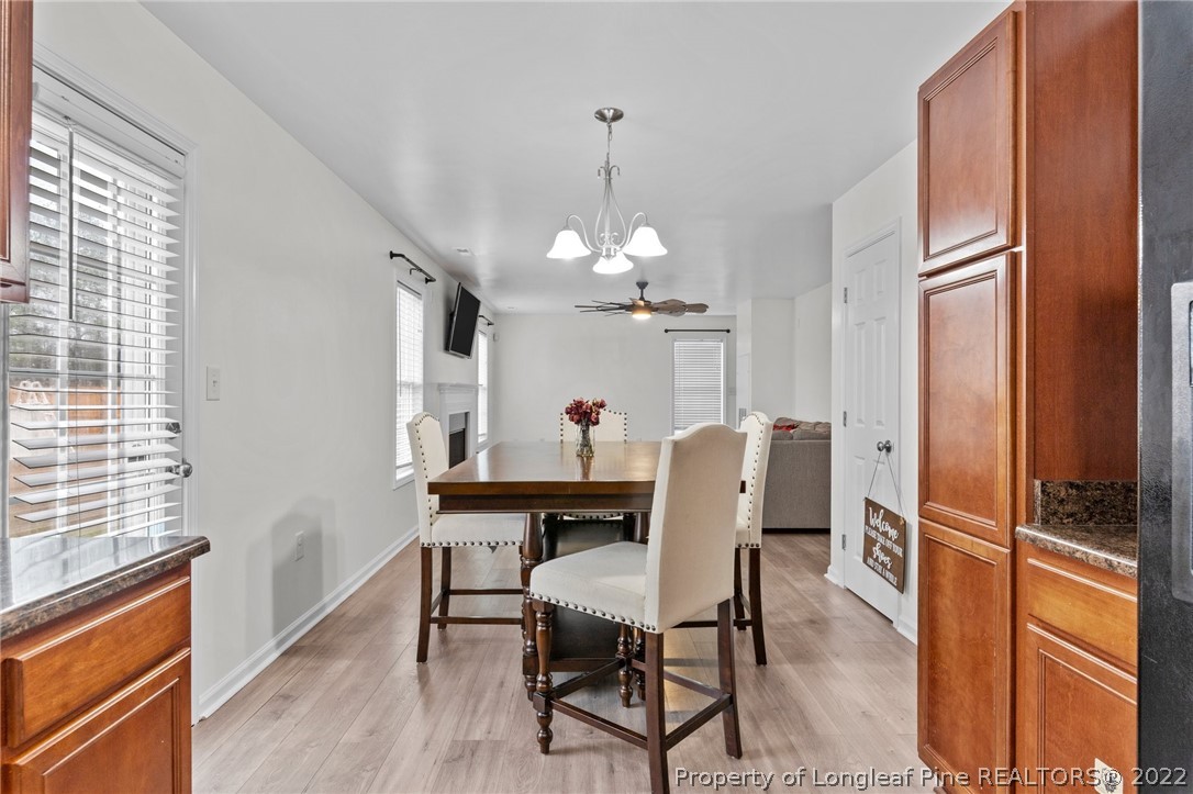 699 Cape Fear Road Raeford, NC 28376 - Photo 6 of 35 a dining room with furniture a chandelier and wooden floor