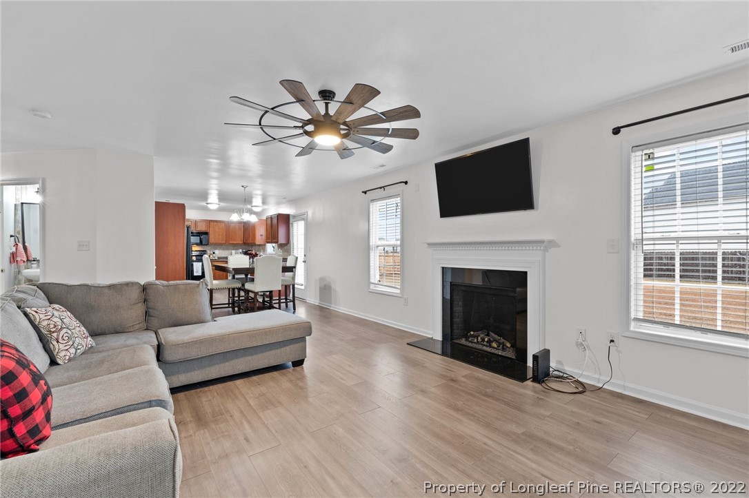 699 Cape Fear Road Raeford, NC 28376 - Photo 10 of 35 a living room with furniture a fireplace and a flat screen tv