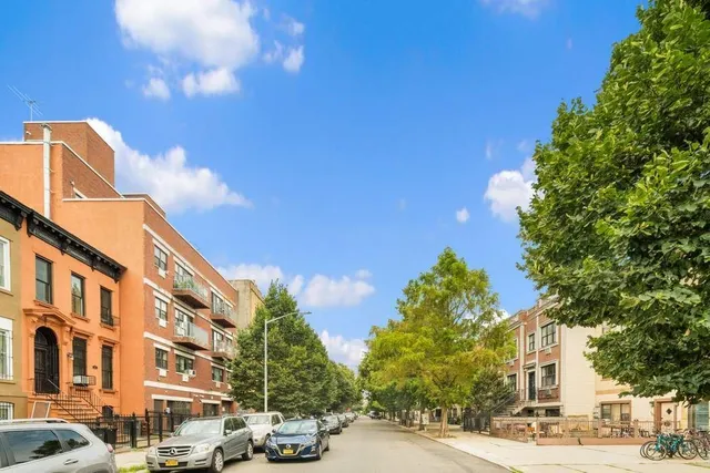 a city street lined with buildings and trees