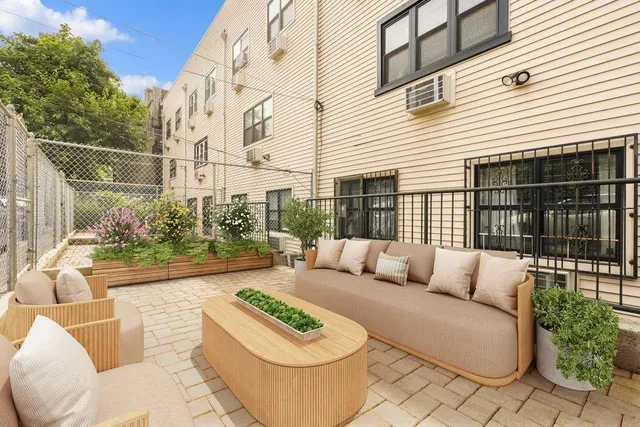 a view of a patio with couches table and chairs and potted plants