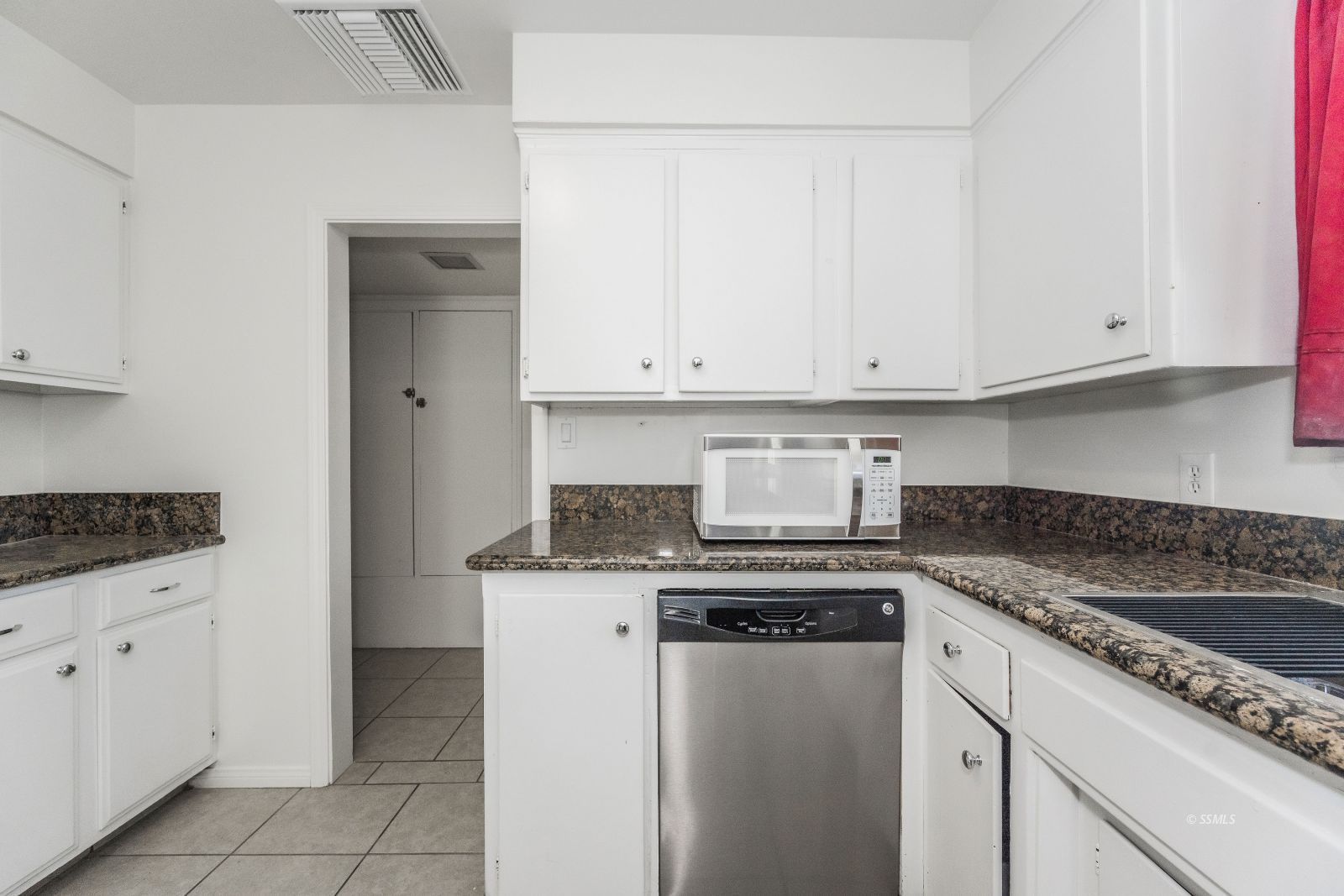 412 East Church Avenue Ridgecrest, CA 93555 - Photo 7 of 39 a kitchen with granite countertop white cabinets and a stove top oven