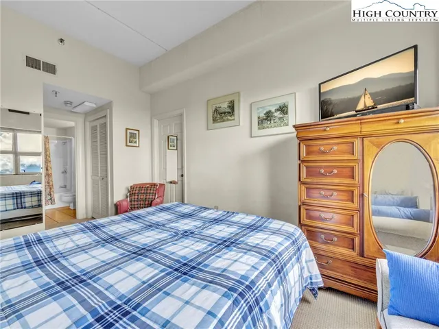 a bedroom with a bed and dresser