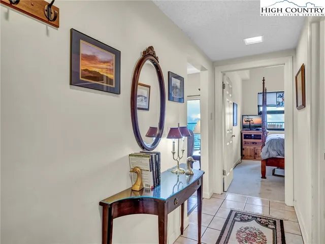 a view of a hallway with workspace and entryway