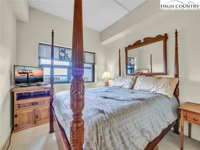 a bedroom with a bed and a tv