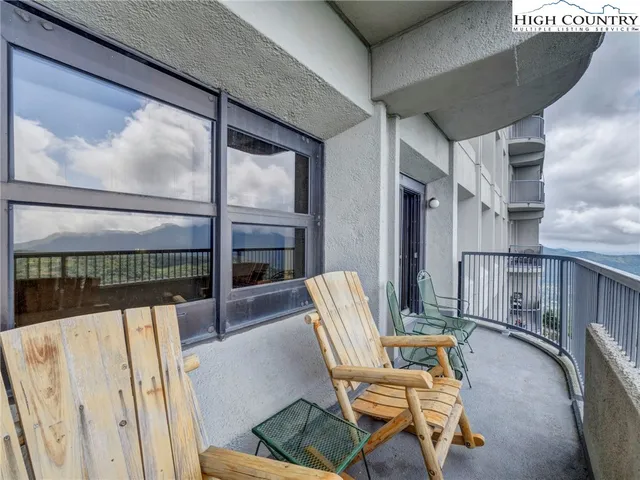 a balcony with table and chairs