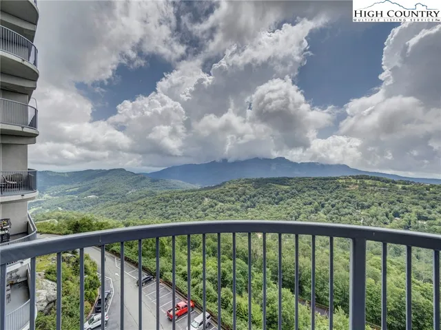 a view of a balcony with wooden fence