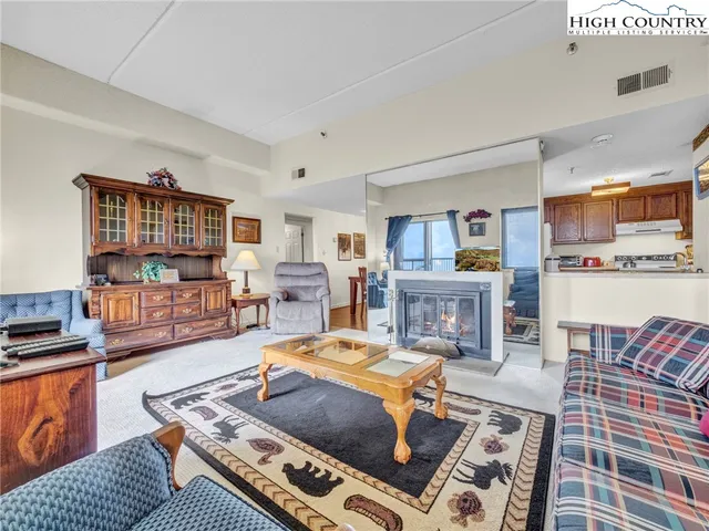 a living room with furniture fireplace and a table
