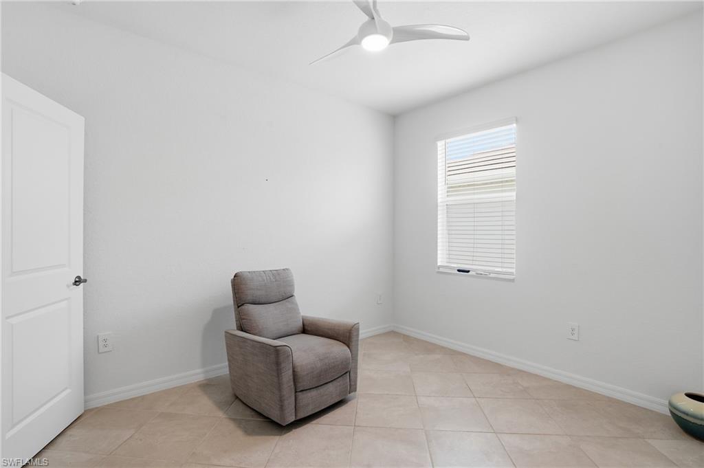 2215 Dragonfruit Way Naples, FL 34120 - Photo 20 of 38 a living room with furniture and a window