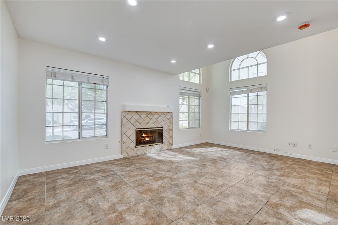 511 Rafkin Place Henderson, NV 89052 - Photo 14 of 64 Unfurnished living room with a tile fireplace, recessed lighting, and light tile patterned floors