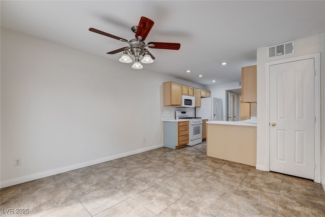 511 Rafkin Place Henderson, NV 89052 - Photo 16 of 64 Kitchen with light countertops, light brown cabinetry, white appliances, ceiling fan, and recessed lighting