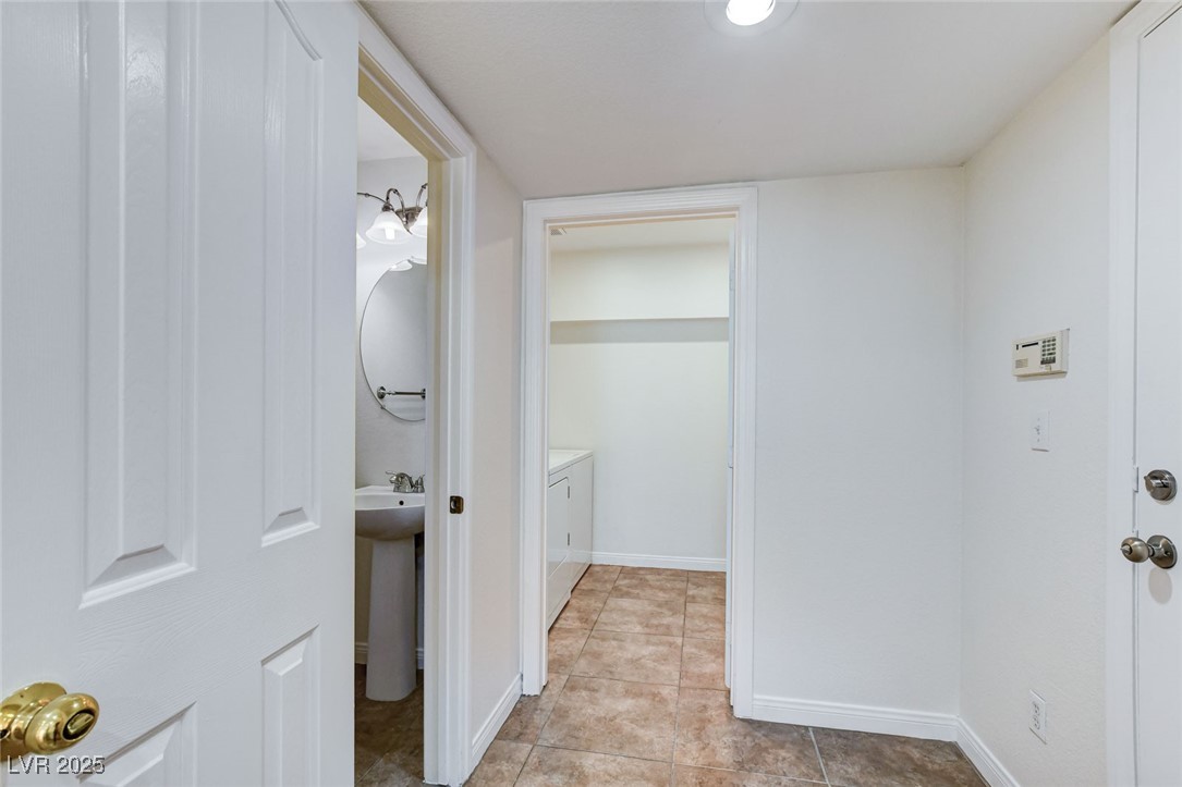 511 Rafkin Place Henderson, NV 89052 - Photo 24 of 64 Laundry area featuring light tile patterned floors and washing machine and dryer