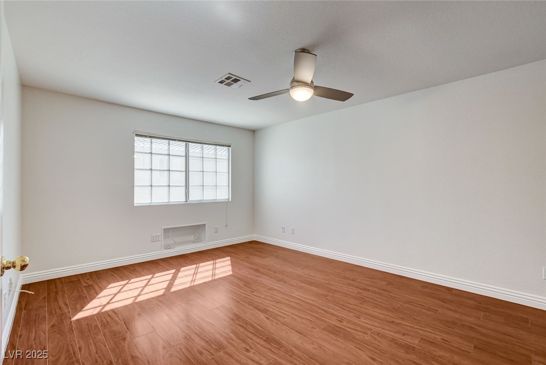 511 Rafkin Place Henderson, NV 89052 - Photo 32 of 64 Empty room with wood finished floors and a ceiling fan