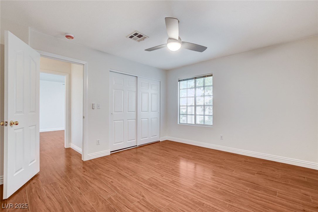 511 Rafkin Place Henderson, NV 89052 - Photo 41 of 64 Unfurnished bedroom featuring light wood finished floors, a closet, and a ceiling fan