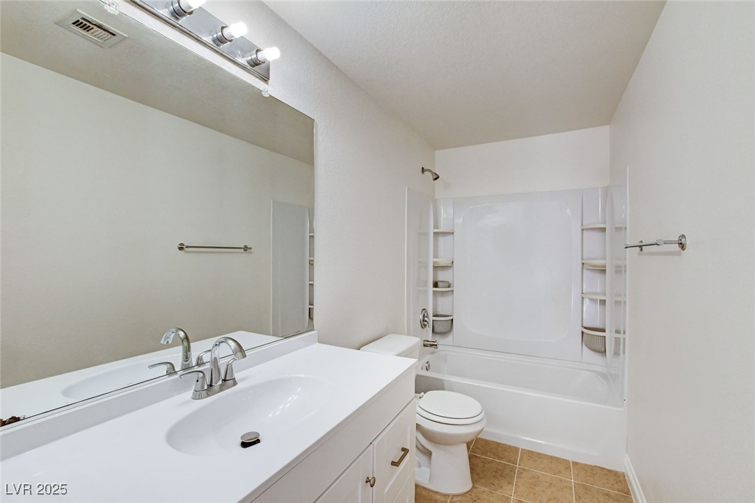 511 Rafkin Place Henderson, NV 89052 - Photo 42 of 64 Bathroom featuring vanity, washtub / shower combination, and light tile patterned floors