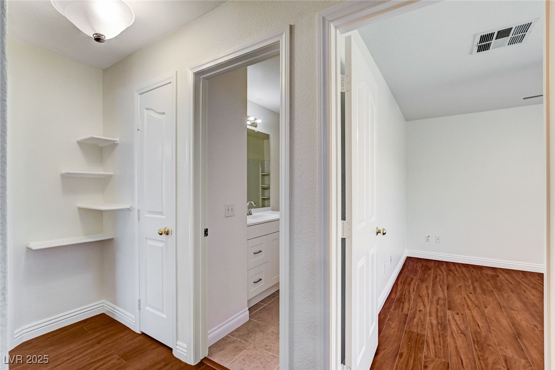 511 Rafkin Place Henderson, NV 89052 - Photo 43 of 64 Hall featuring dark wood-style floors and baseboards