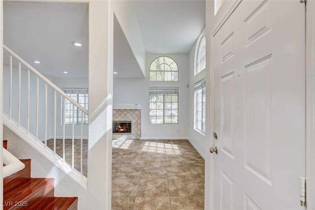 511 Rafkin Place Henderson, NV 89052 - Photo 10 of 64 Entryway featuring a tiled fireplace, stairway, light tile patterned floors, and recessed lighting