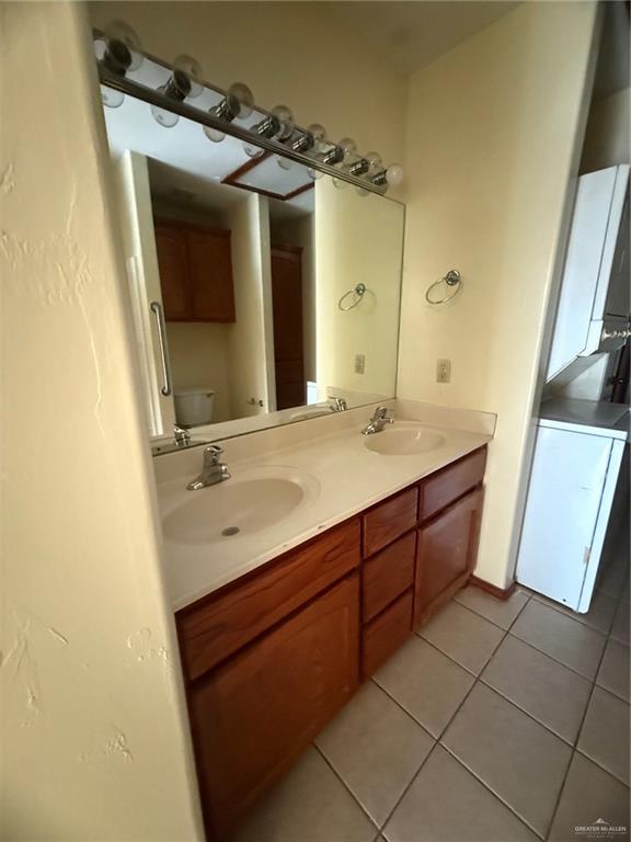 2000 Circle Drive, Unit 4 Mission, TX 78572 - Photo 11 of 18 a bathroom with a double vanity sink and mirror