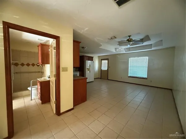 a view of a hallway with bathroom and sink