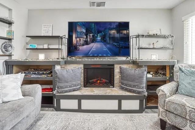 a living room with furniture and a fireplace