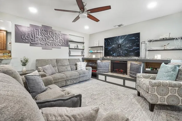 a living room with furniture and a fireplace