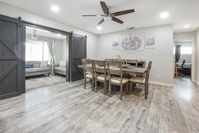 a view of a a dining room with furniture window and wooden floor