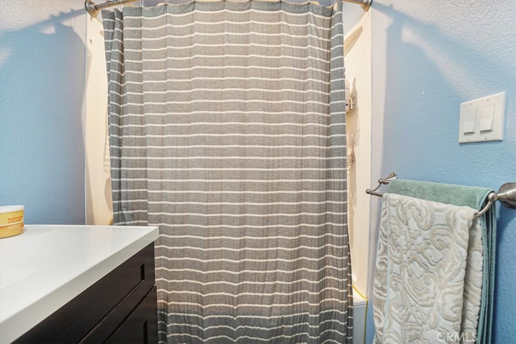 33962 Clark Lane Yucaipa, CA 92399 - Photo 19 of 48 a bathroom with a sink and a shower