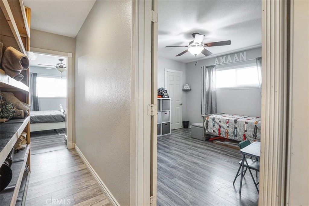 33962 Clark Lane Yucaipa, CA 92399 - Photo 21 of 48 a hallway with a bed and a chandelier