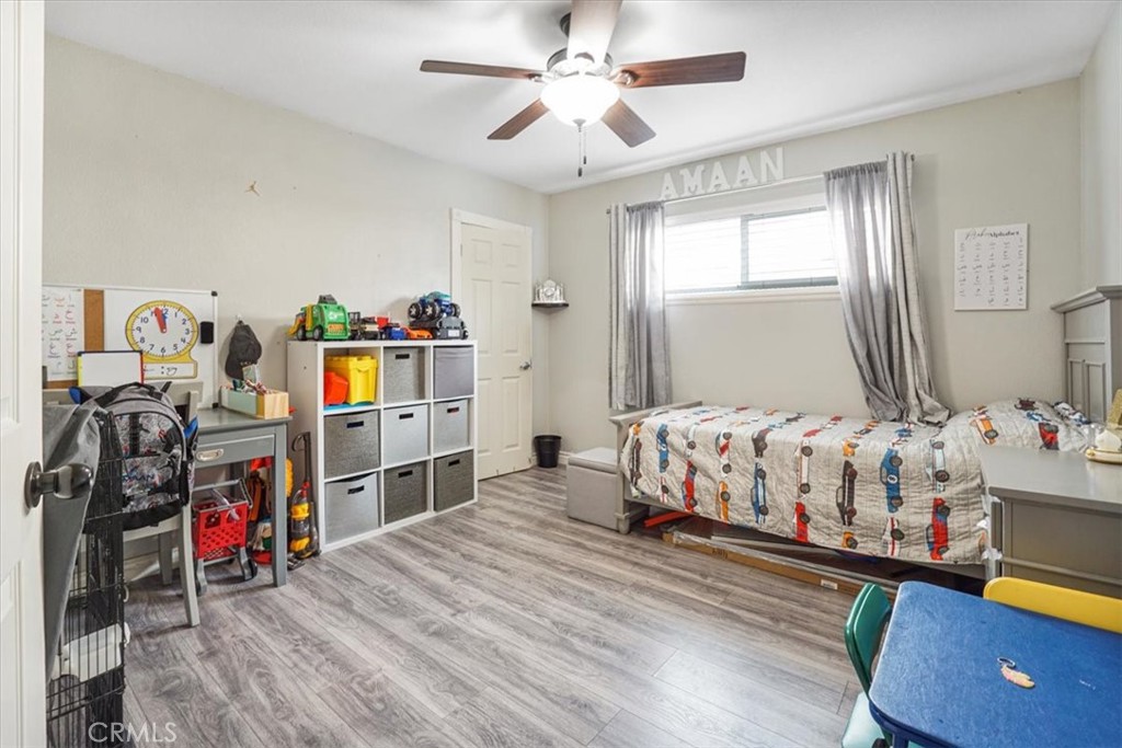 33962 Clark Lane Yucaipa, CA 92399 - Photo 23 of 48 a bedroom with bed and a chandelier