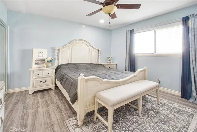 a spacious bedroom with a bed and a chandelier