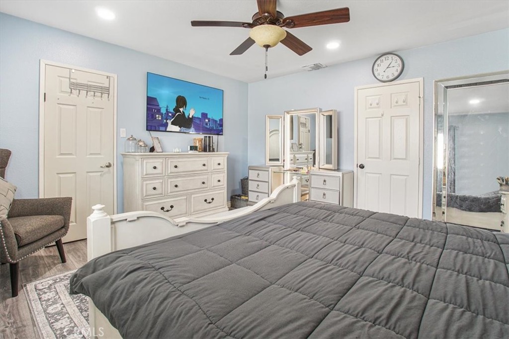 33962 Clark Lane Yucaipa, CA 92399 - Photo 27 of 48 a bedroom with a bed and a chandelier