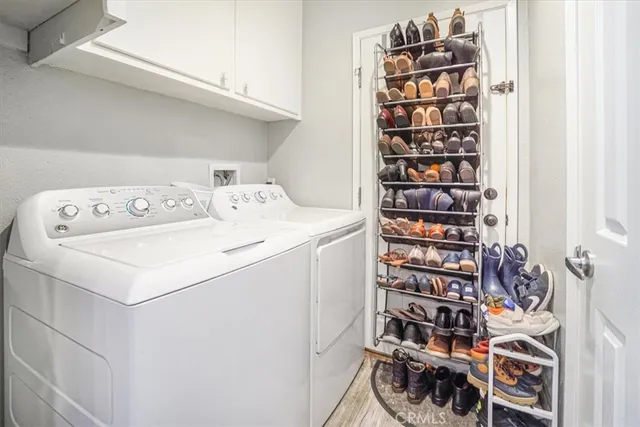 a utility room with dryer washer and a view of living room