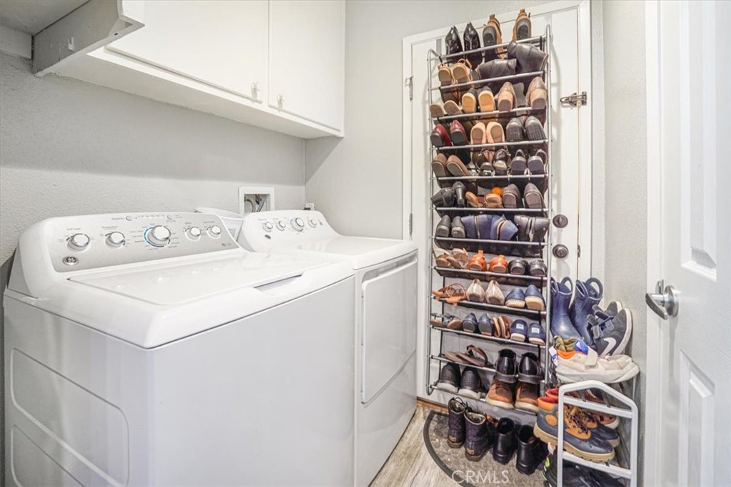 33962 Clark Lane Yucaipa, CA 92399 - Photo 28 of 48 a utility room with dryer washer and a view of living room