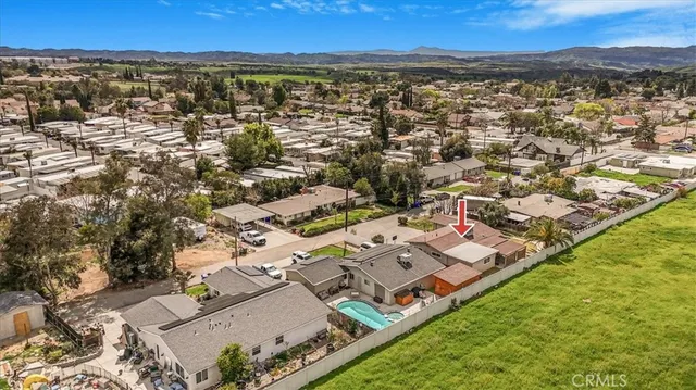 an aerial view of residential houses with outdoor space and river