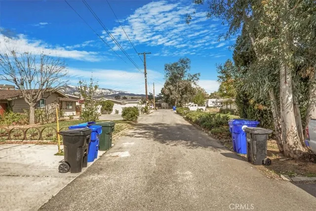 a view of a road with trees in the background