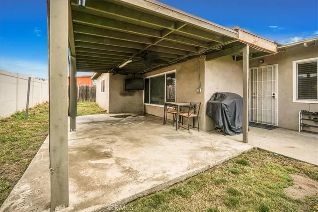 a view of a porch with furniture and a yard