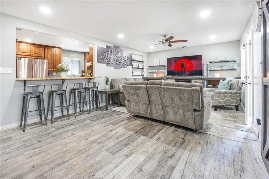 33962 Clark Lane Yucaipa, CA 92399 - Photo 8 of 48 a living room with furniture a flat screen tv and kitchen view