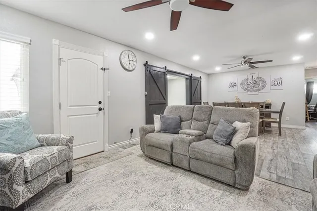 a living room with furniture and a ceiling fan