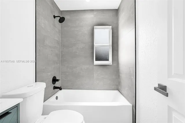 a bathroom with a tub and a shower