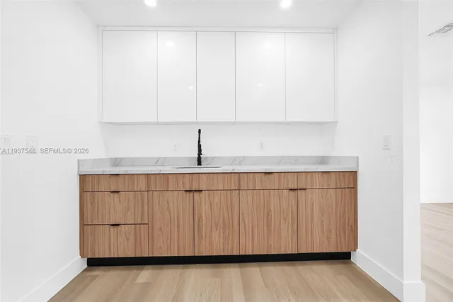 a kitchen with a white cabinets and a sink