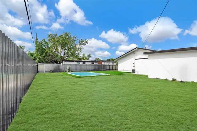 a view of yard with swimming pool and sitting area
